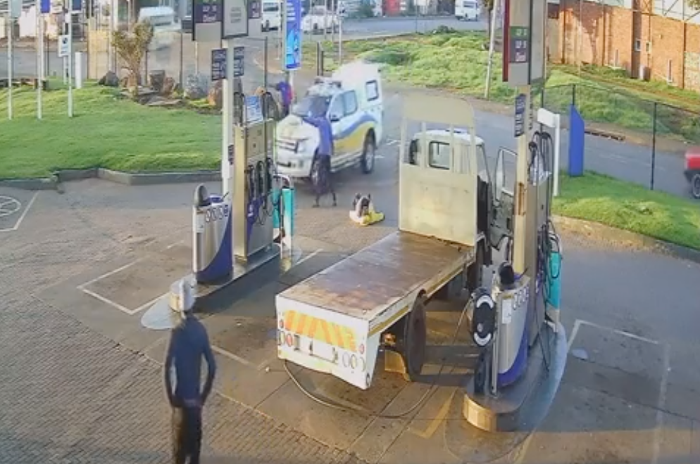 The scene of a man robbing people at a petrol station.