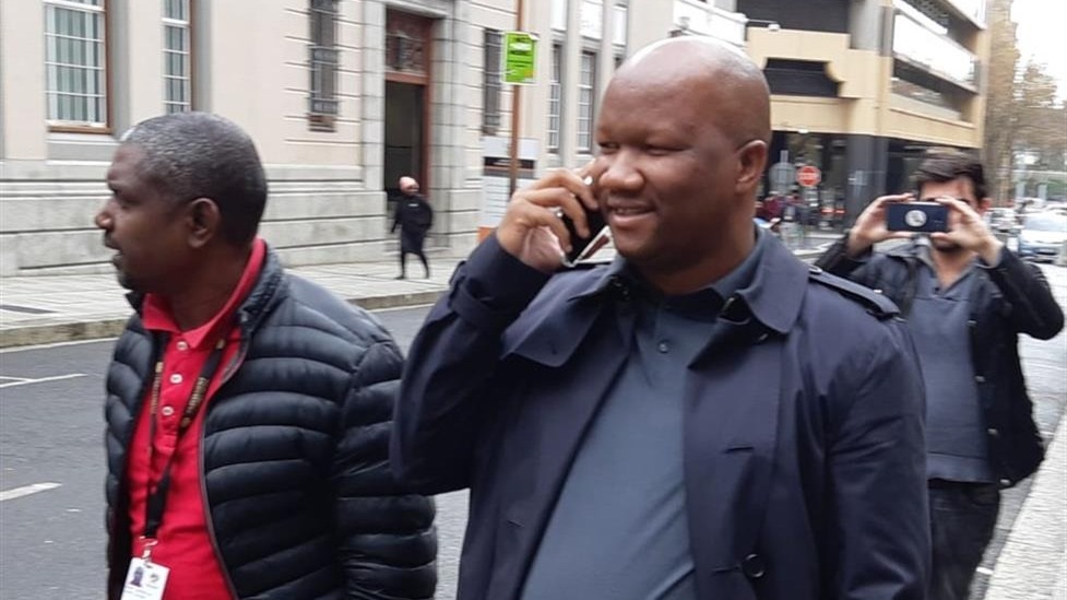 EFF MP Godrich Gardee accompanies fellow MP Marshall Dlamini outside the Cape Town Magistrate's Court. 