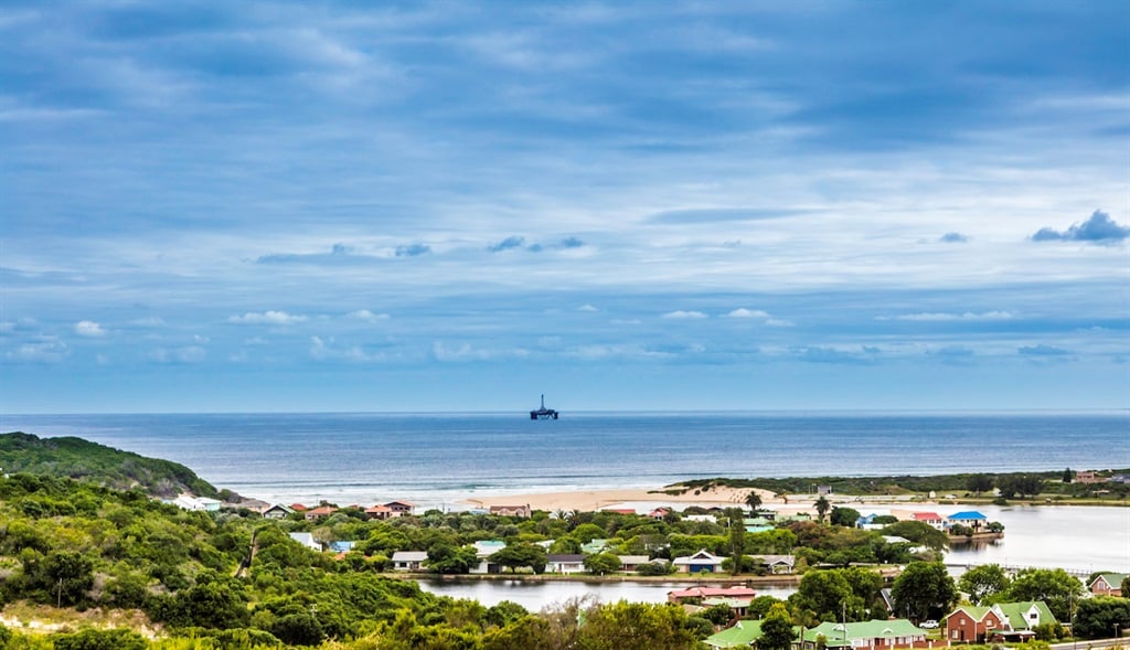 An oil rig visible over the meeting of the Hartenbos river and the sea, near Mossel Bay. (Getty)