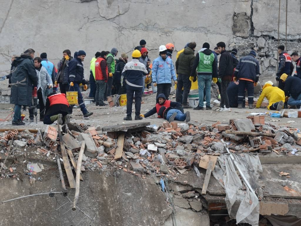 Rescue personnel search through the rubble for victims and survivors in Kahramanmaras, the day after a 7.8-magnitude earthquake struck Turkey's southeast.